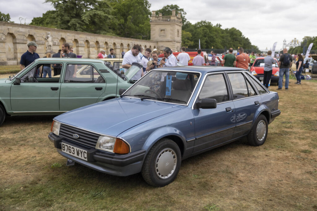 Blue Ford Escort Mk3 parked on grass