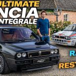 Two Lancia Delta Integrale cars parked on a gravel driveway in front of a brick building
