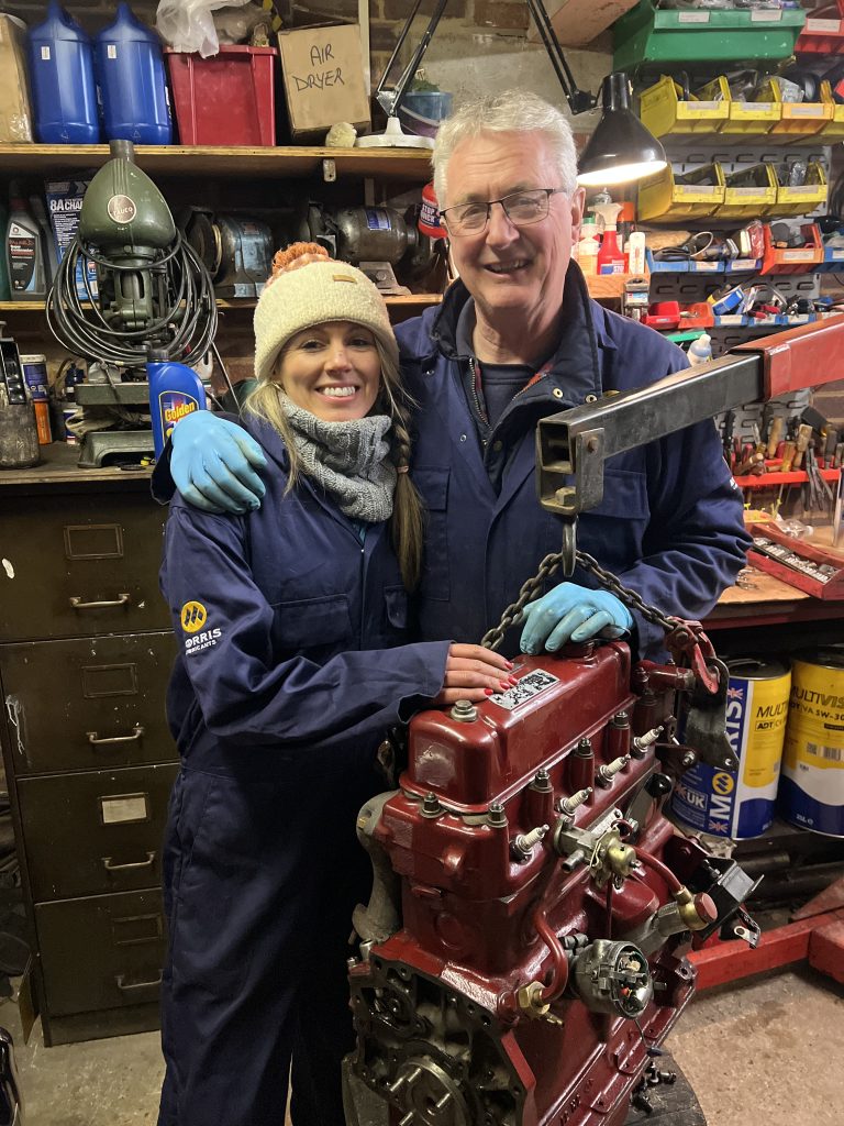 Two mechanics with restored engine