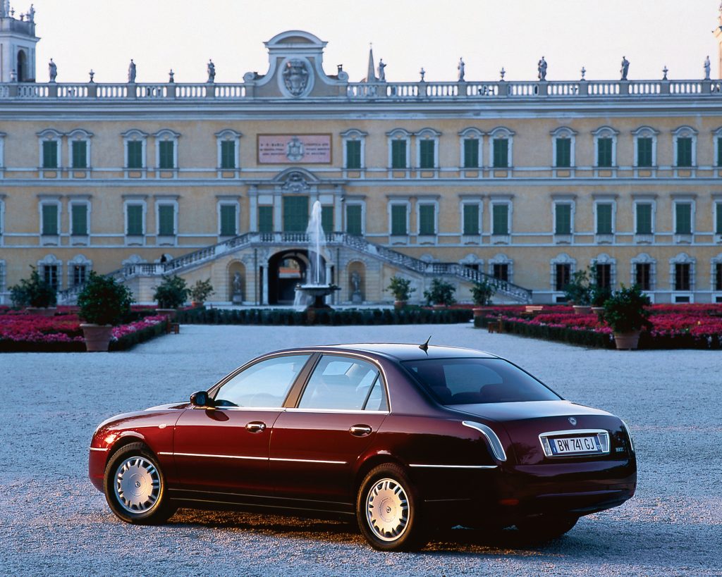 Car parked on gravel driveway in front of building