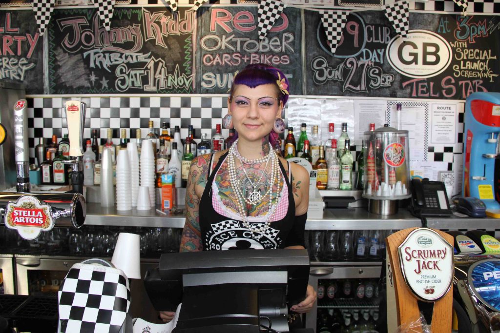 Woman standing at till in a cafe