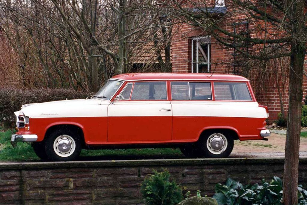 Red and white car parked in front of red brick building
