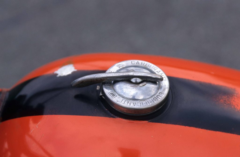 Fuel cap lid of red motorbike fuel tank