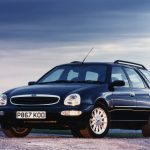 Black Ford Scorpio Ultima parked on gravel