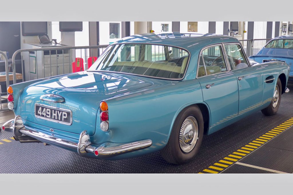 Rear view of a blue car parked on rubber matting
