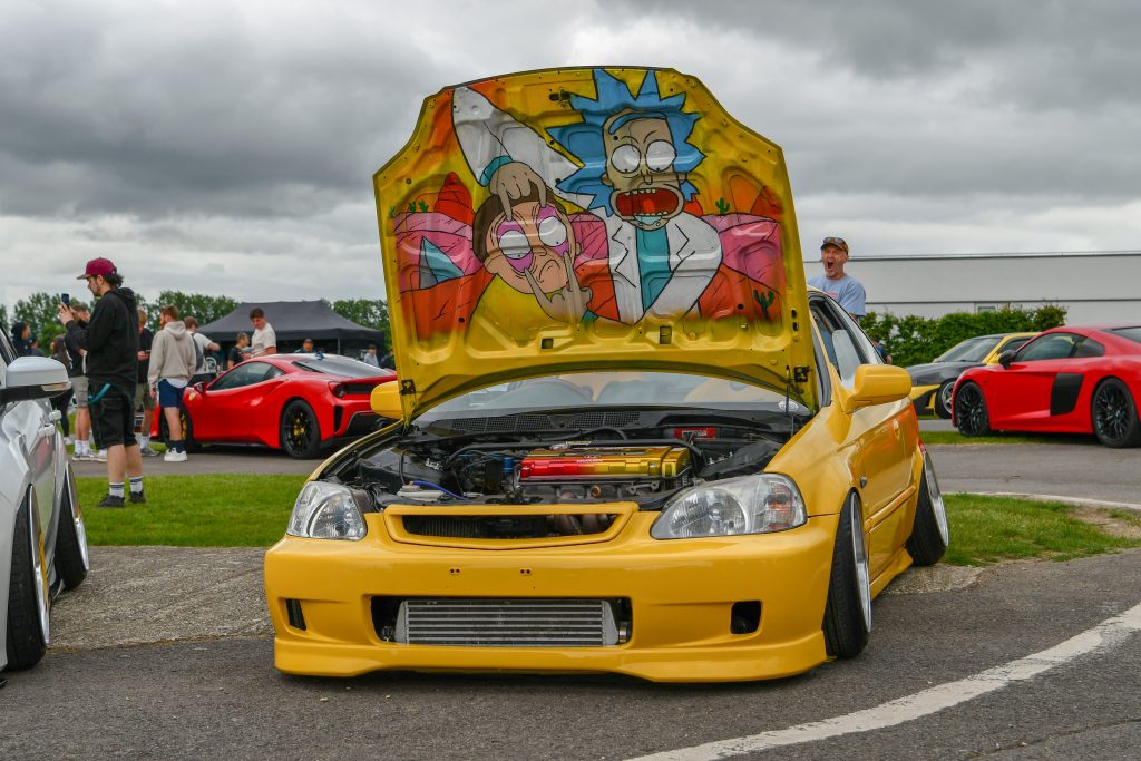 Yellow car with bonnet lifted exposing engine bay