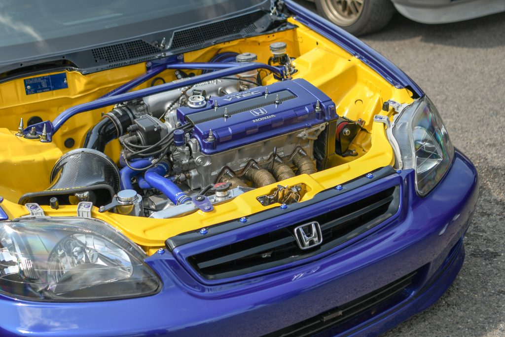 Blue car with bonnet lifted exposing engine bay