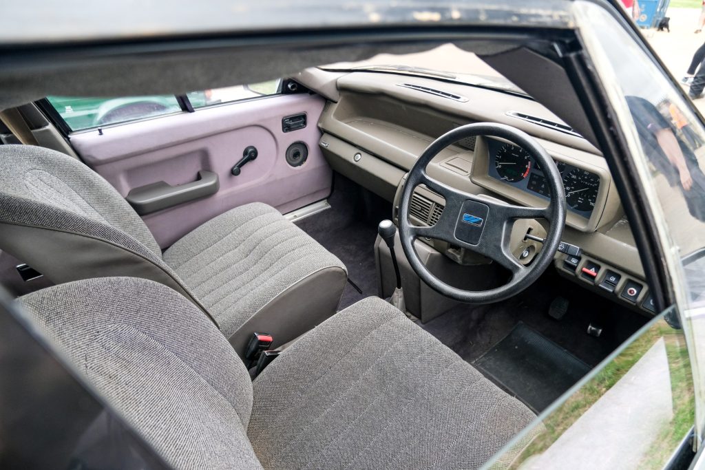 Open car window showing interior cabin and two front car seats