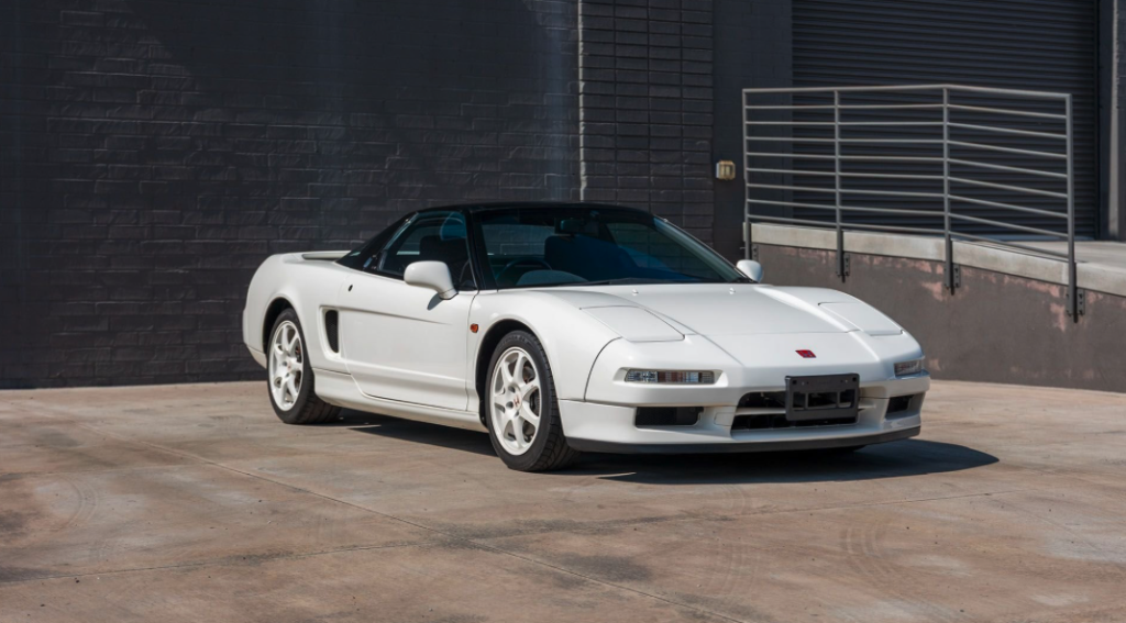 White Honda NSX parked up in a concrete parking lot