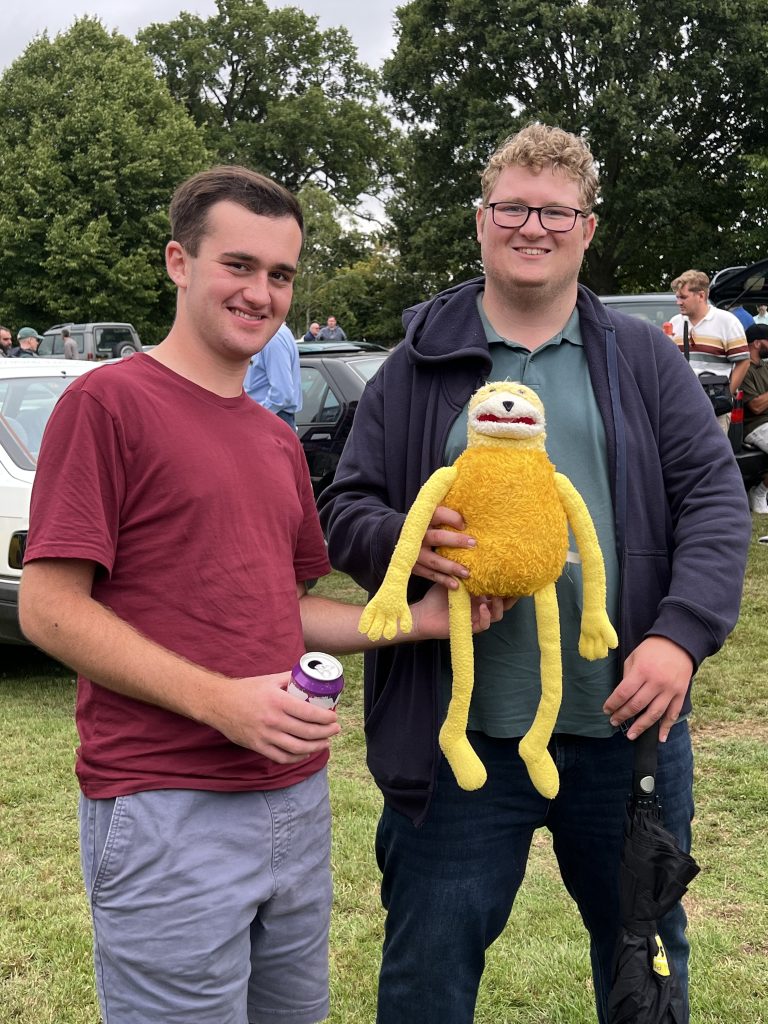 Two men standing in a field 