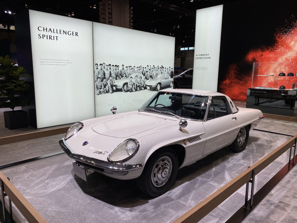 White Mazda Cosmo on display in a museum