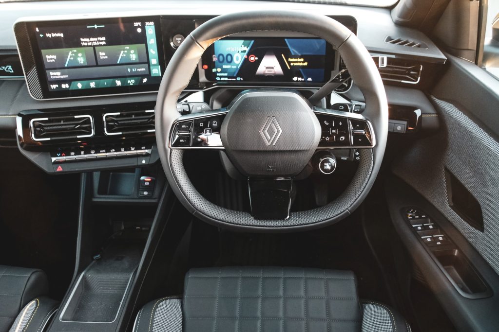 Interior cabin of Renault car showing steering wheel and infotainment system
