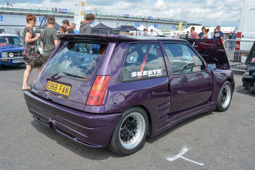 Rear view of purple car parked on tarmac