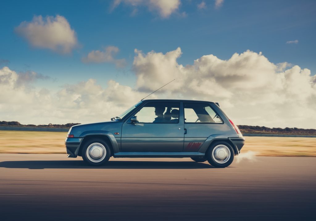 Side view of Renault 5 GT Turbo driving on track