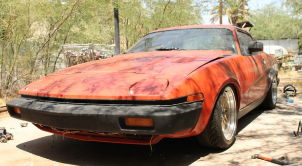 Red TR7 parked in a driveway