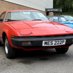 Four cars parked in a car park at a car sales