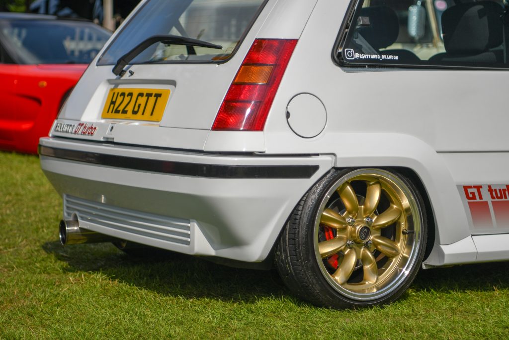Rear of parked up white Renault 5 GT Turbo with gold alloy
