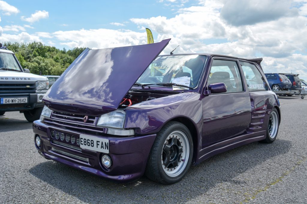Purple parked car with bonnet open