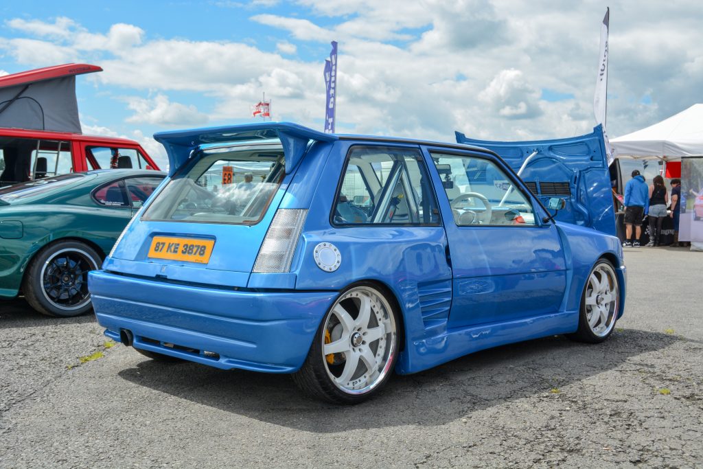 Rear view of parked blue Renault 5 GT Turbo with the bonnet raised