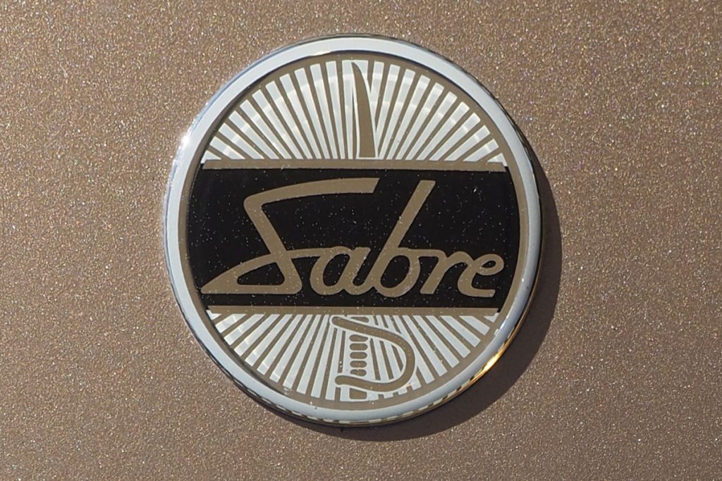 Close up of a black and gold car badge