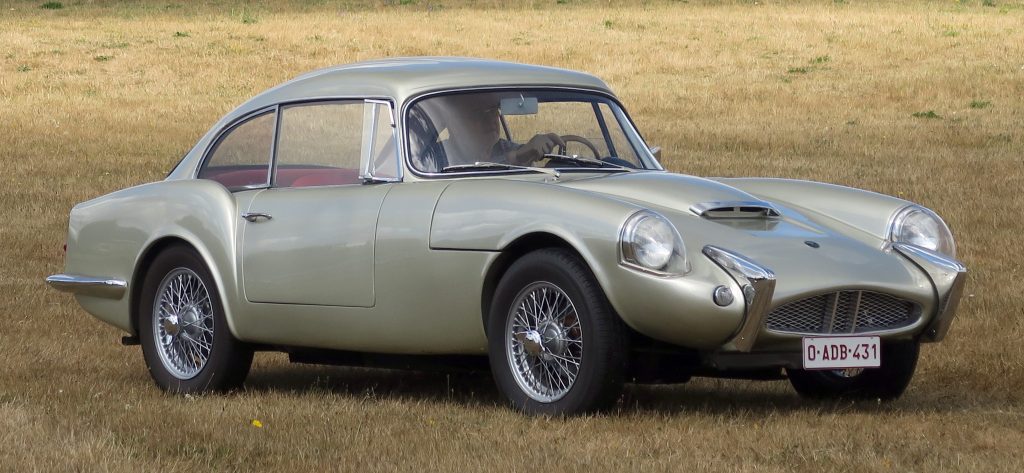 Side view of a gold Reliant Sabre driving through field