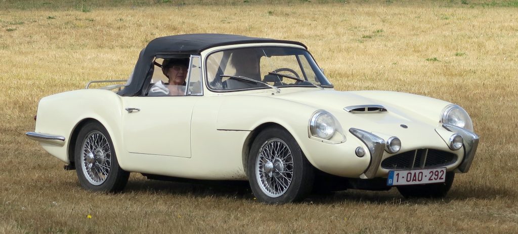 White Reliant Sabre driving through grass field