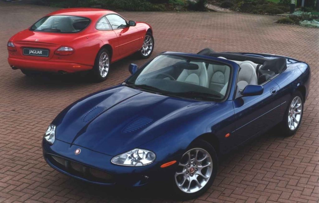 Two Jaguar cars parked on paved driveway