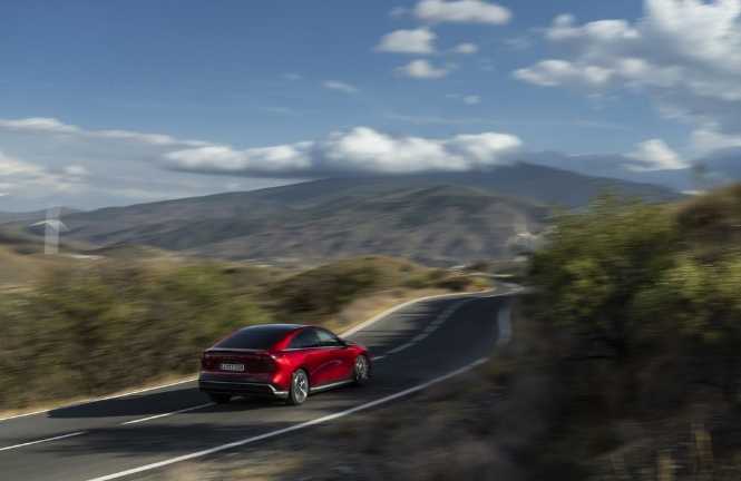 Mazda driving along scenic road