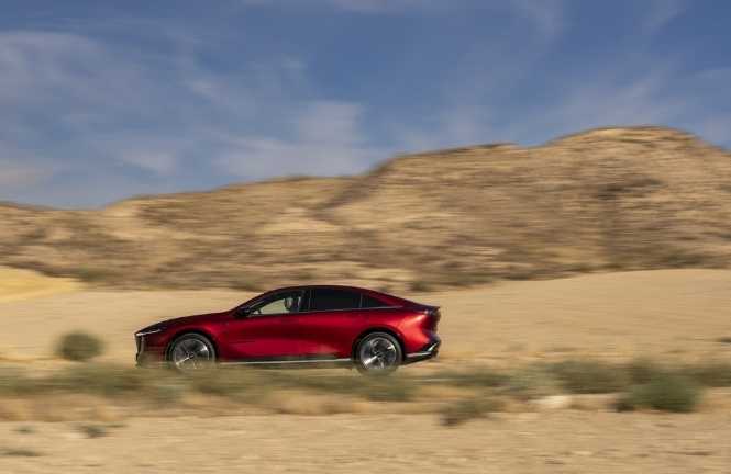 Mazda driving along scenic road