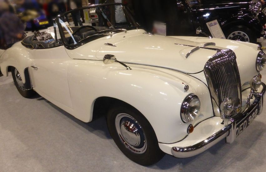 White Daimler parked inside a showroom