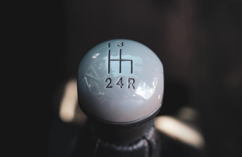 Close up of a manual gear shifter knob inside a car