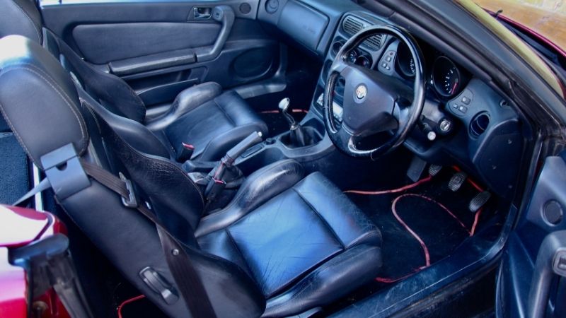 Black leather interior of an Alfa Romeo GTV