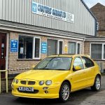 Yellow MG car outside MOT garage