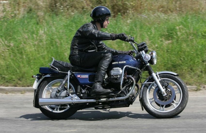 Moto Guzzi V1000 Convert being ridden along a road with grass verge behind