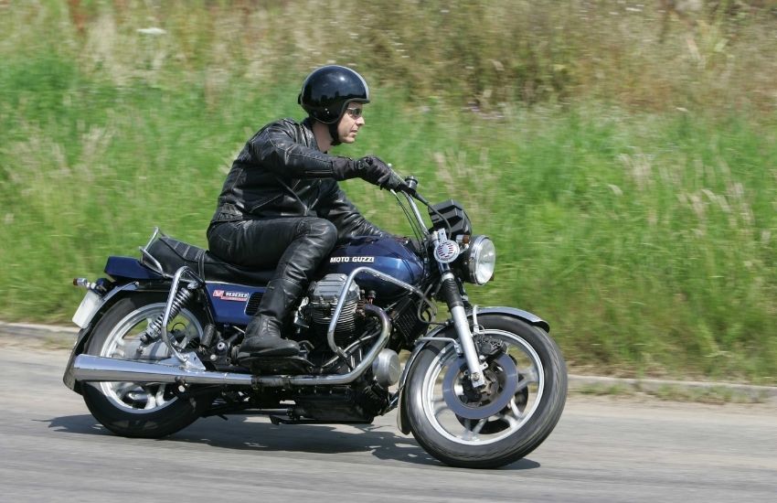 Moto Guzzi V1000 Convert being ridden along a road with grass verge behind