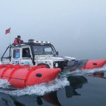 Floating Landrover Defender sailing through water