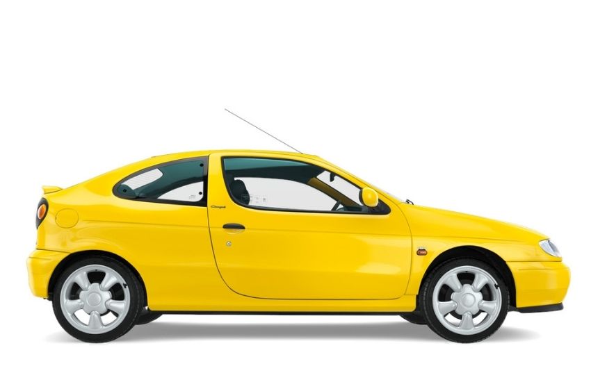 Side view of a parked yellow Renault Megane