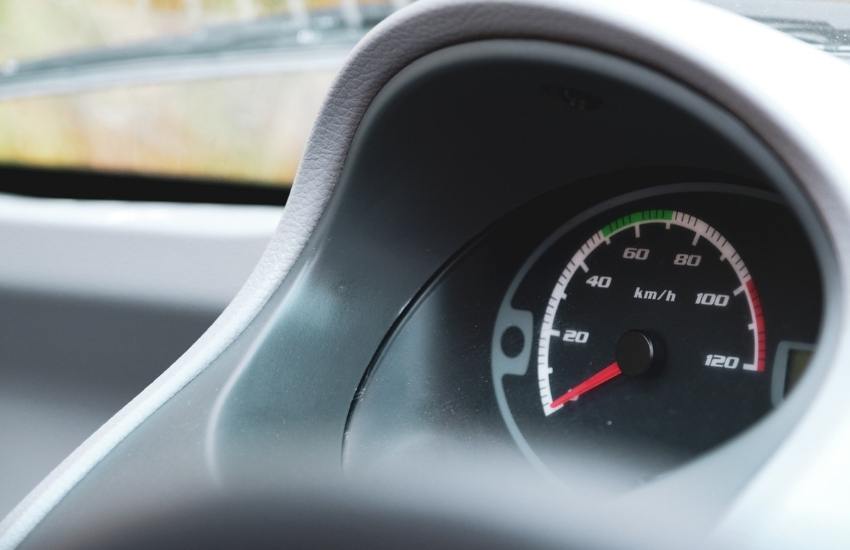 Close up of a car's speedometer showing 0 MPH
