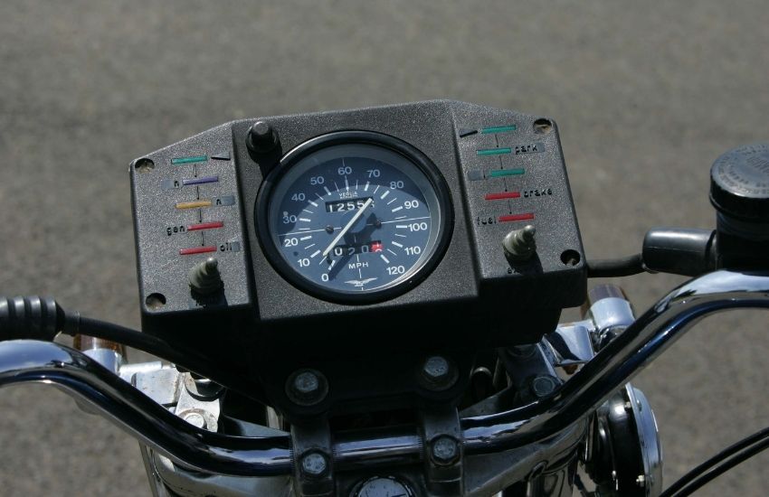 The speedometer and handlebars of a classic motorbike