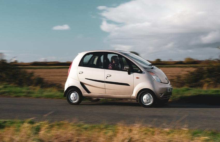 Tata Nano driving along a country lane with fields in the background