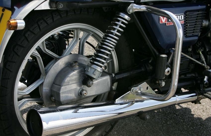 Close up of the rear wheel and exhaust pipe of a motorbike