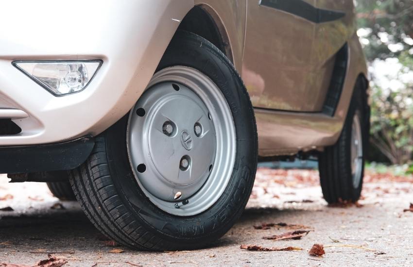 Close up of a car's front wheel with the rear wheel in the background