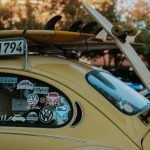 Yellow car covered in car stickers