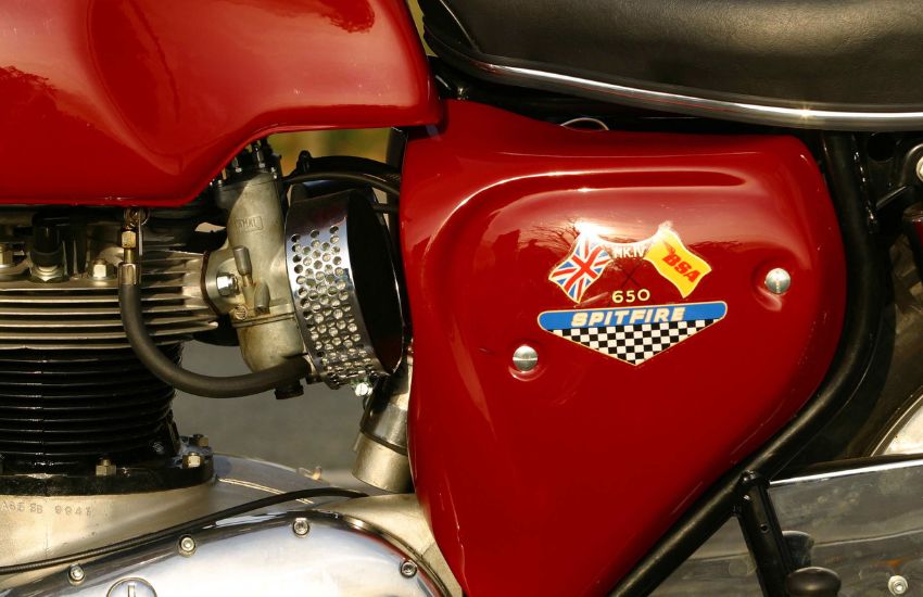 Side view of red metal tank on a motorbike