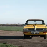 Yellow Vauxhall Viva classic car parked on the tarmac of an airfield
