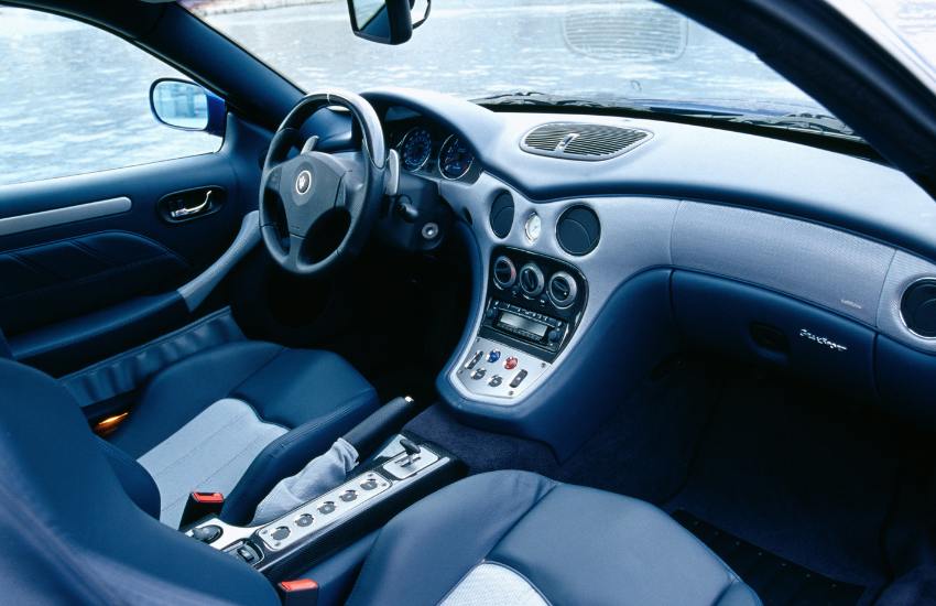 Black leather interior cabin of a Maserati 00s exotic car