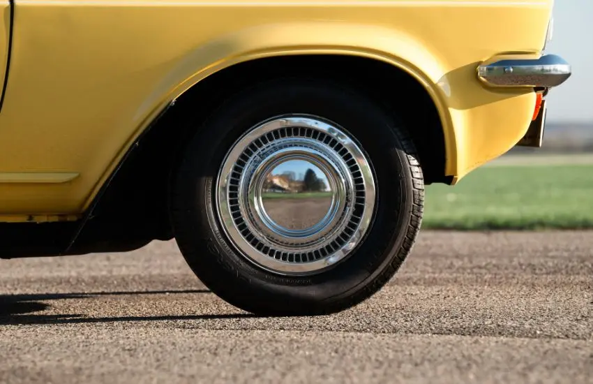 Rear wheel of a yellow classic car suitable for agreed value cover