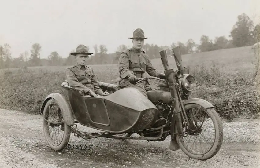 Photocopy of greyscale period photograph of two men sitting on a motorbike