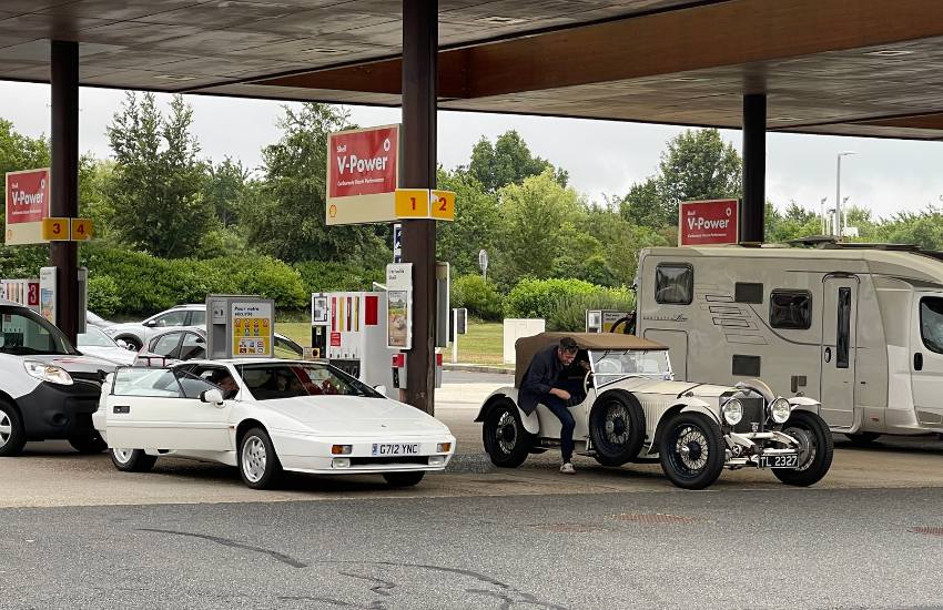 Multiple vehicles parked in the forecourt of a petrol station