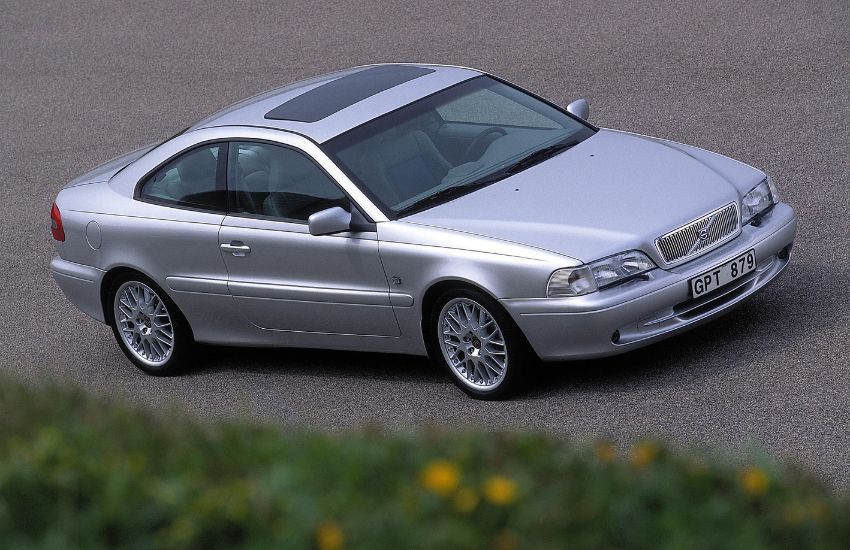 Side view of a silver Volvo car parked up on a tarmac road